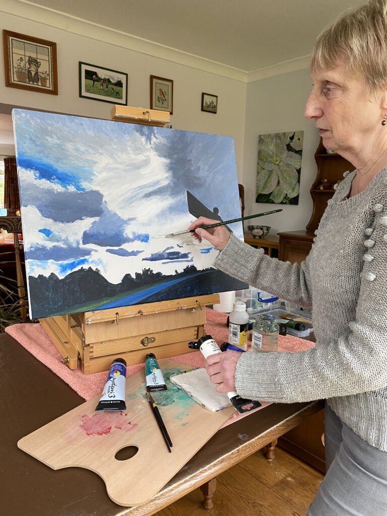 Christine Pratt paints in her studio.